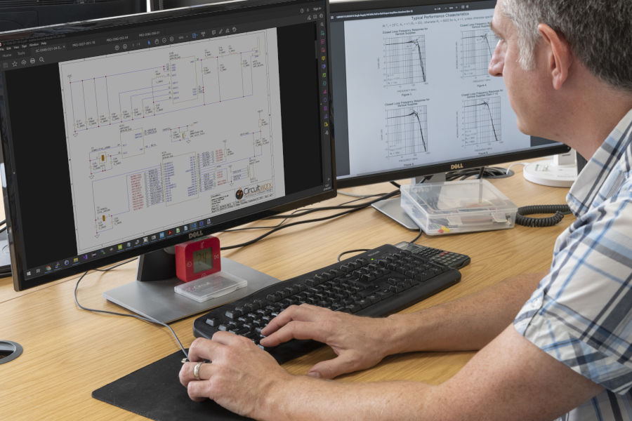 Engineer working on electronic circuit schematic design