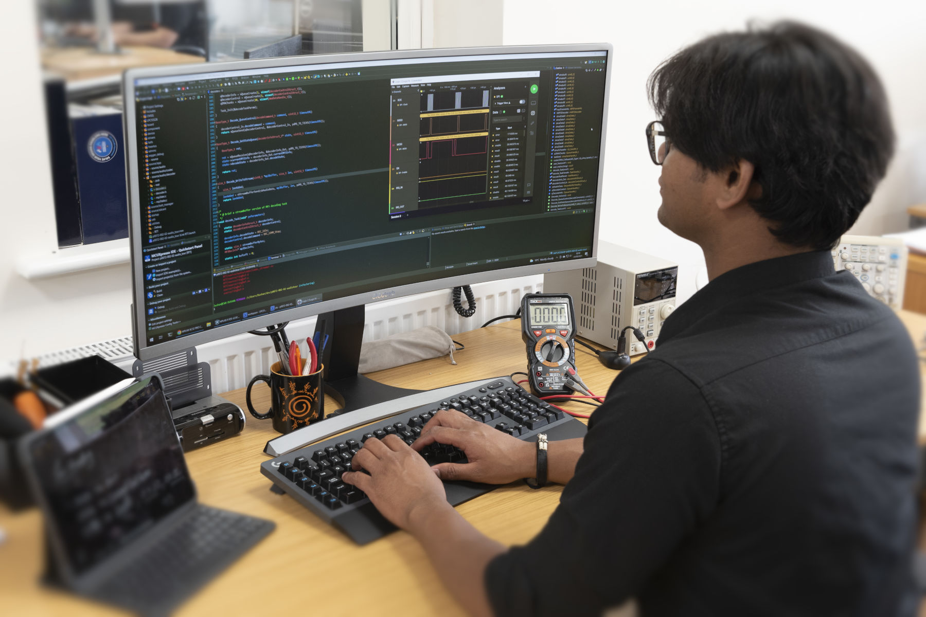 Software Engineer writing embedded code and examining timing waveforms