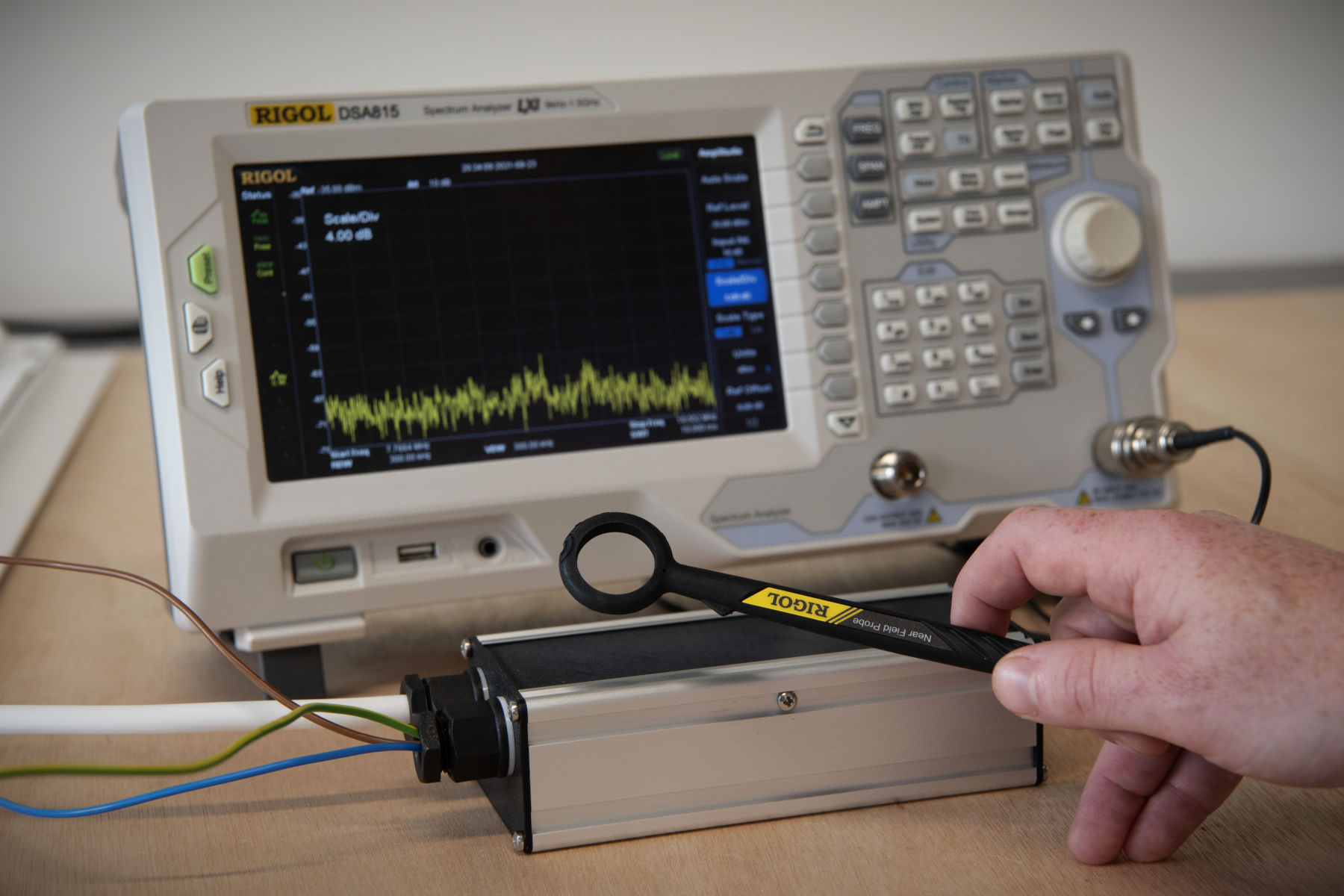 Hand holding EMC probe during precompliance testing