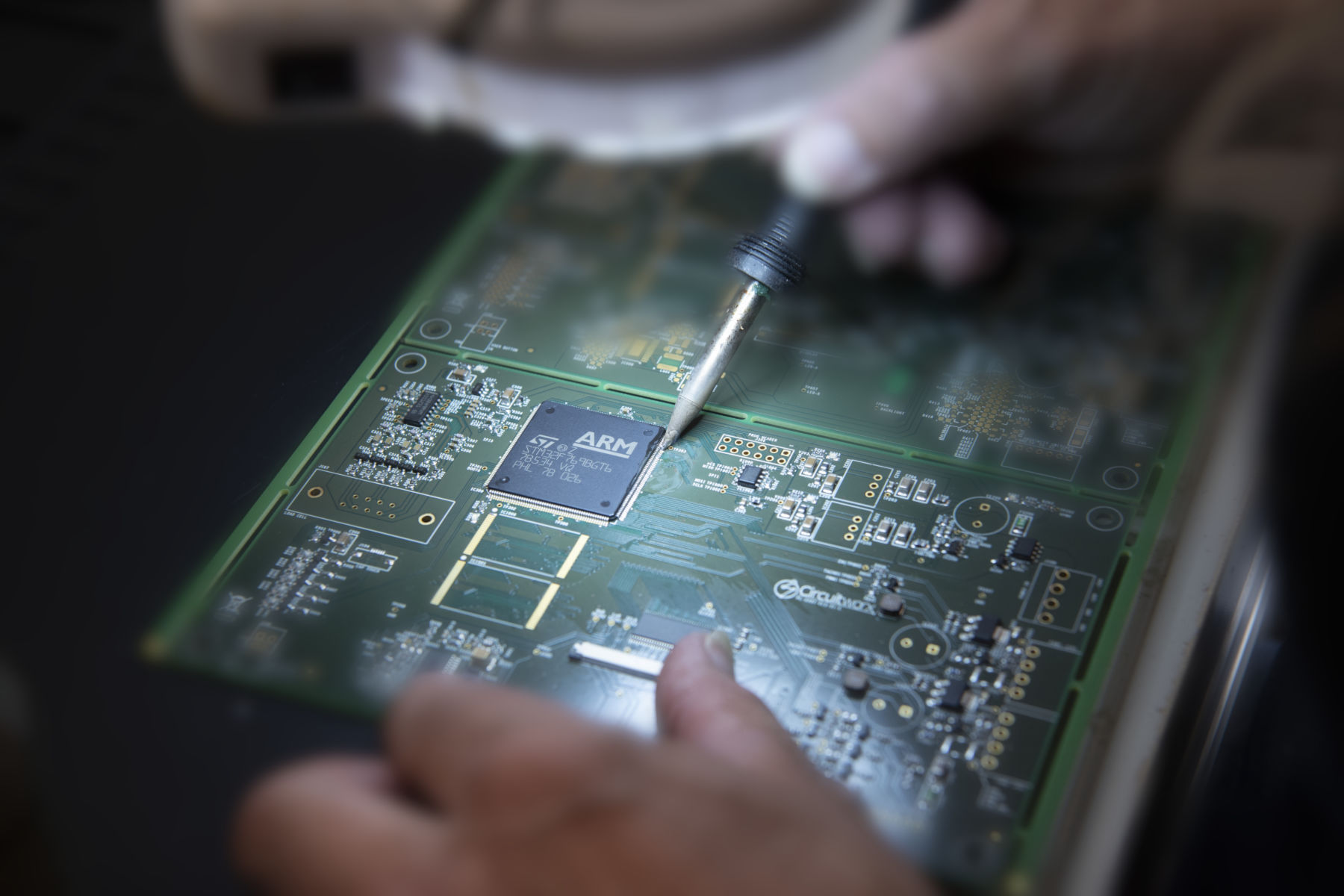 Soldering iron being used in hand assembly of PCB